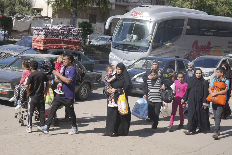 Palestinians stream south in Gaza as Israel urges a mass evacuation and conducts brief raids